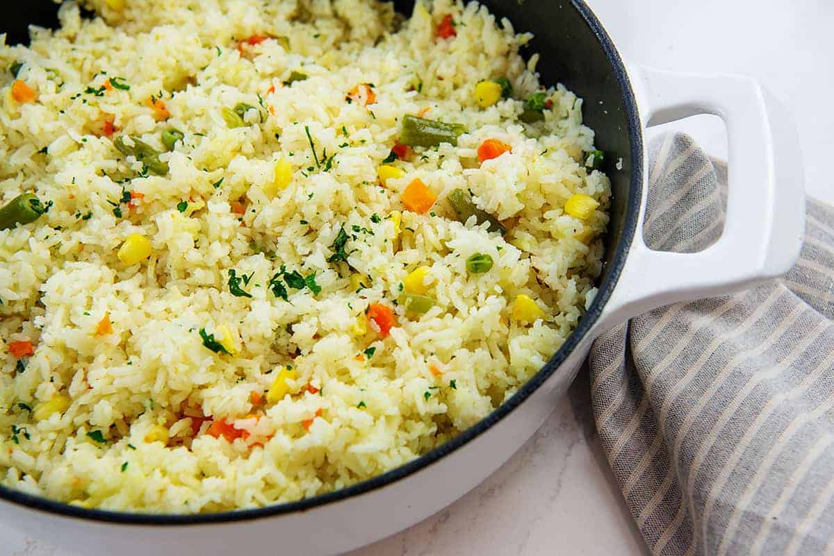 rice with vegetables in white pot.