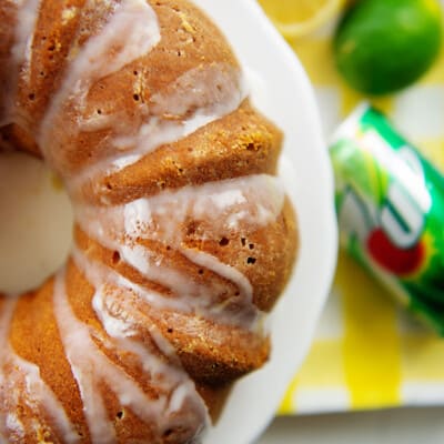 overhead view of 7 Up cake on white cake stand next to cans of 7 up.