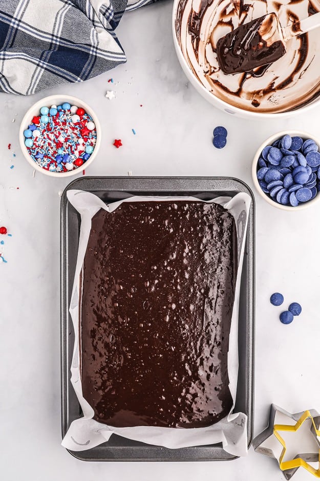 brownie batter in metal baking dish.