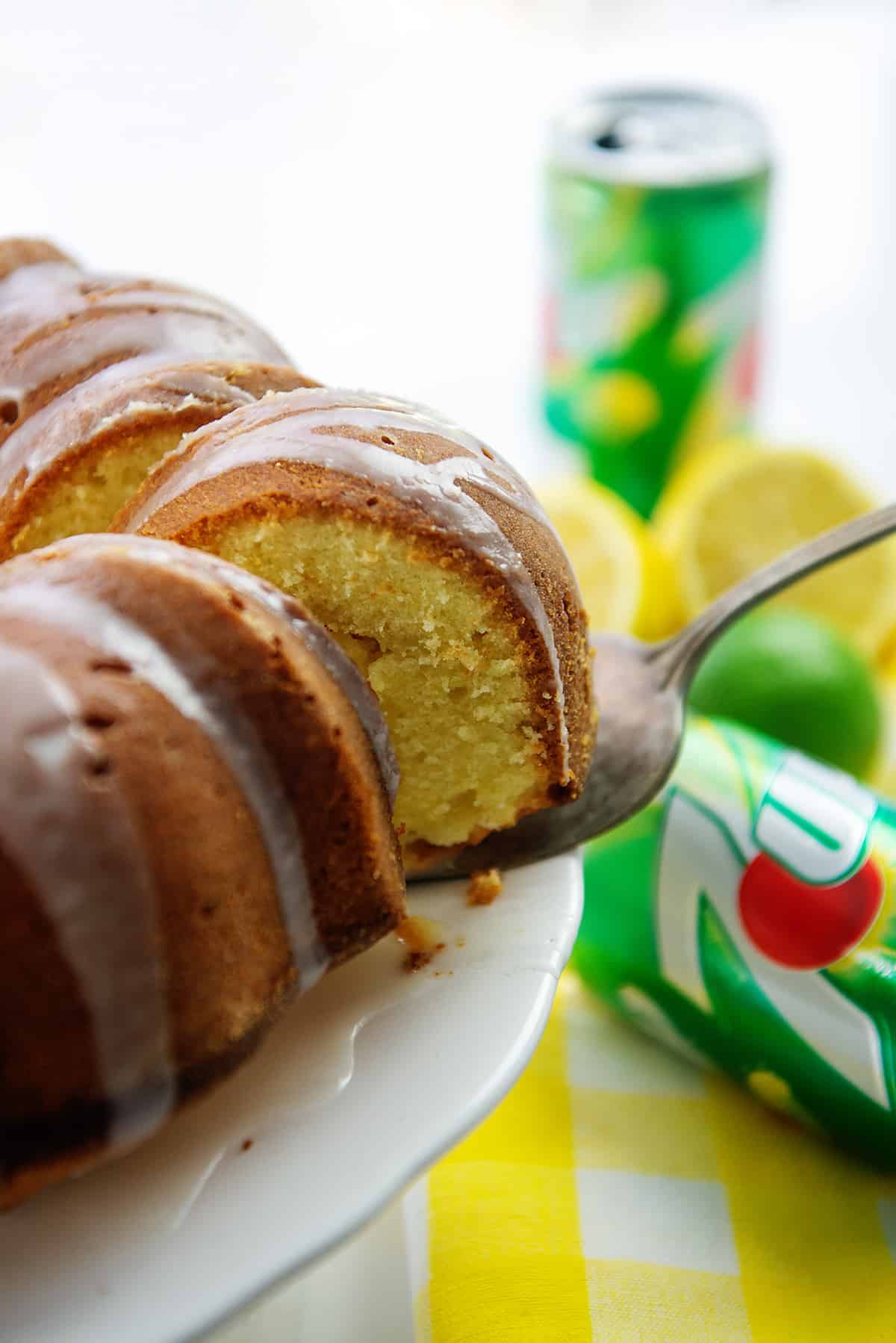 7 up cake on cake server next to cans of 7 up soda.