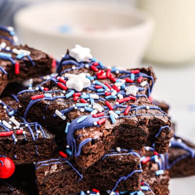 stack of star shaped brownies on white plate.