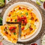 Slice of burrito casserole being removed from dish.