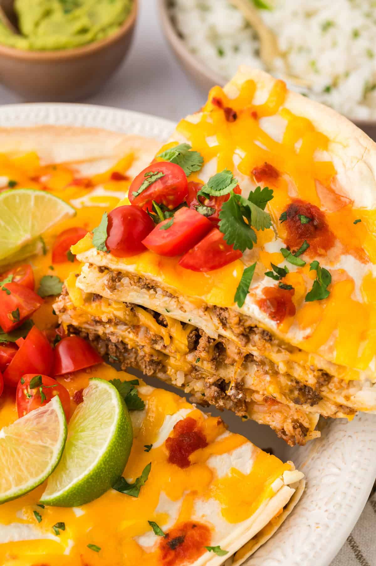 Slice of burrito casserole being lifted out of pie plate.