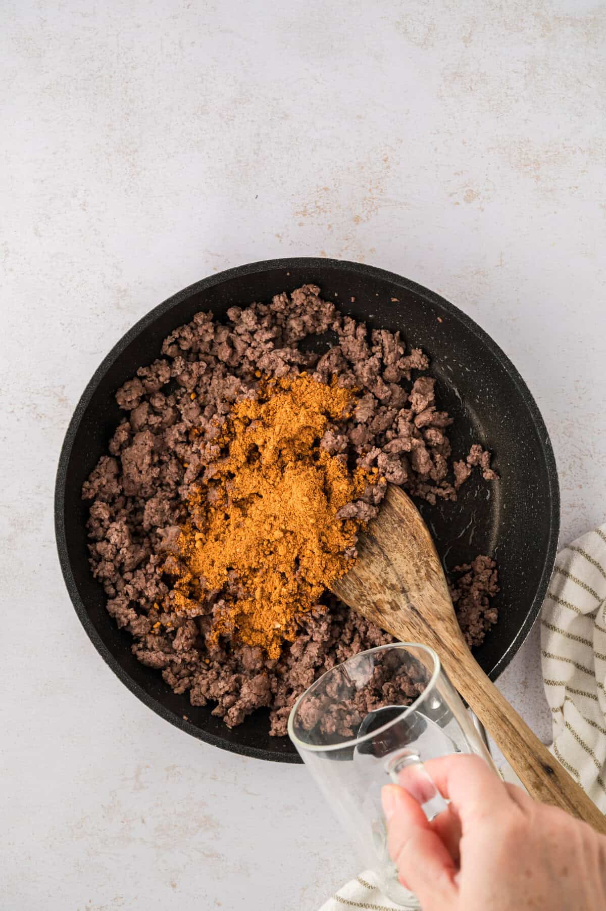 Ground beef with taco seasoning in skillet.