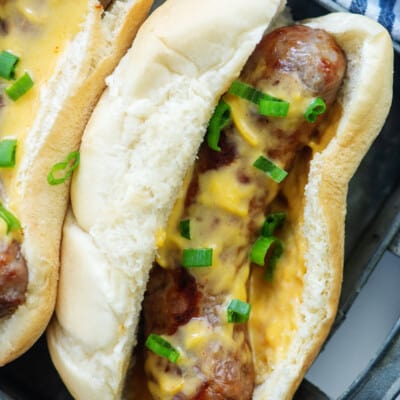 cheesy brats in bun on tray.