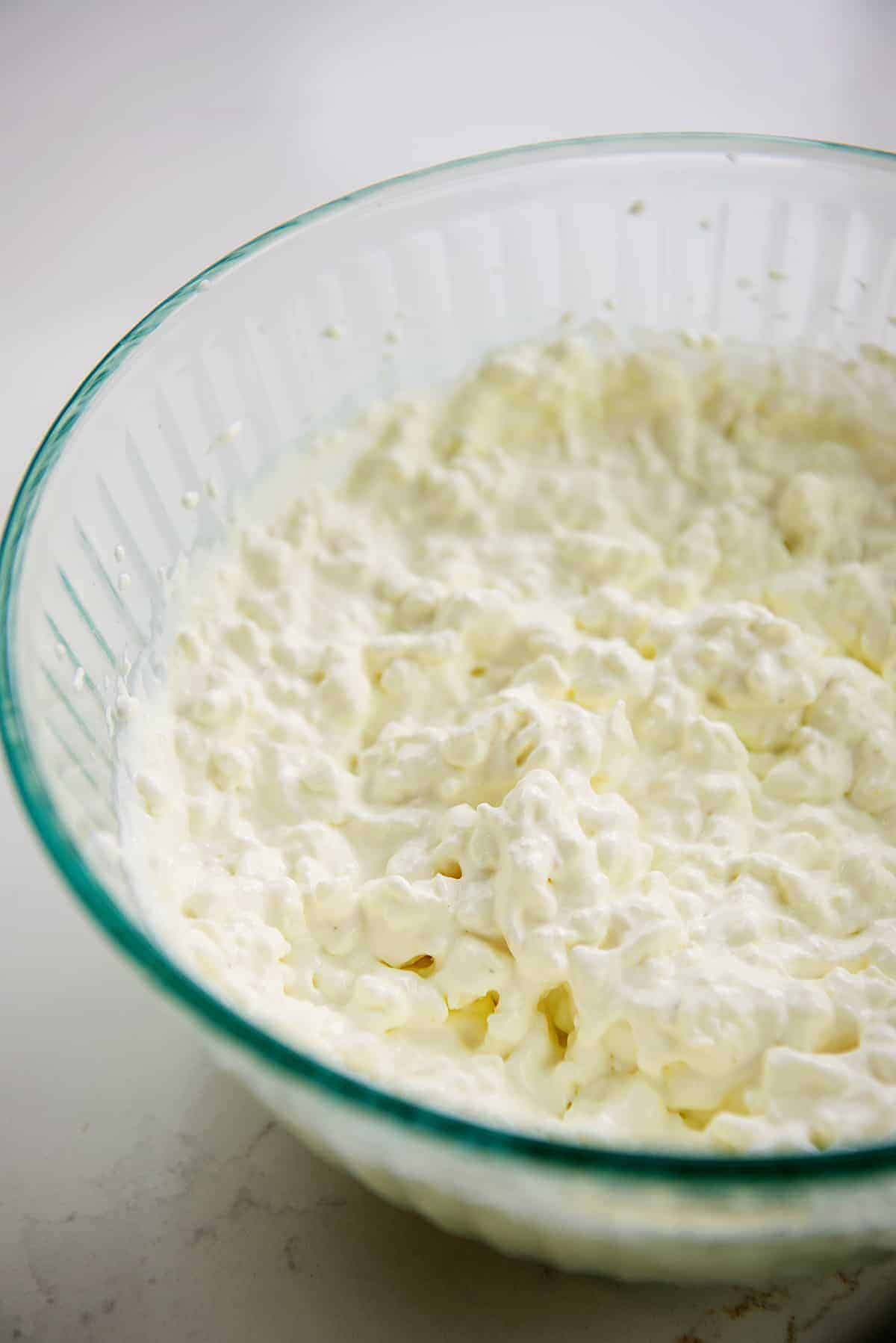 cream cheese, cottage cheese, and sour cream in glass bowl.
