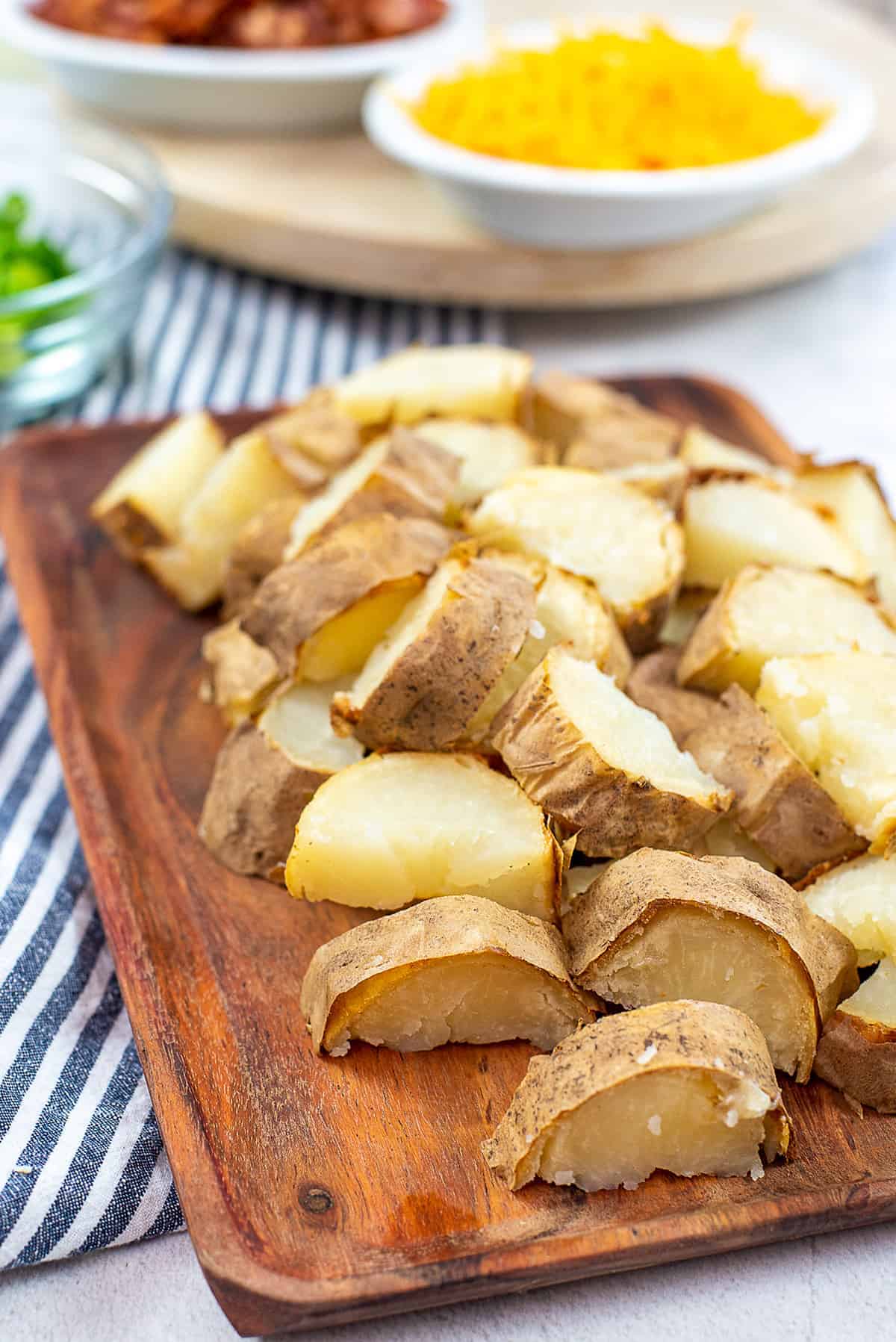 chopped potatoes on wooden cutting board.