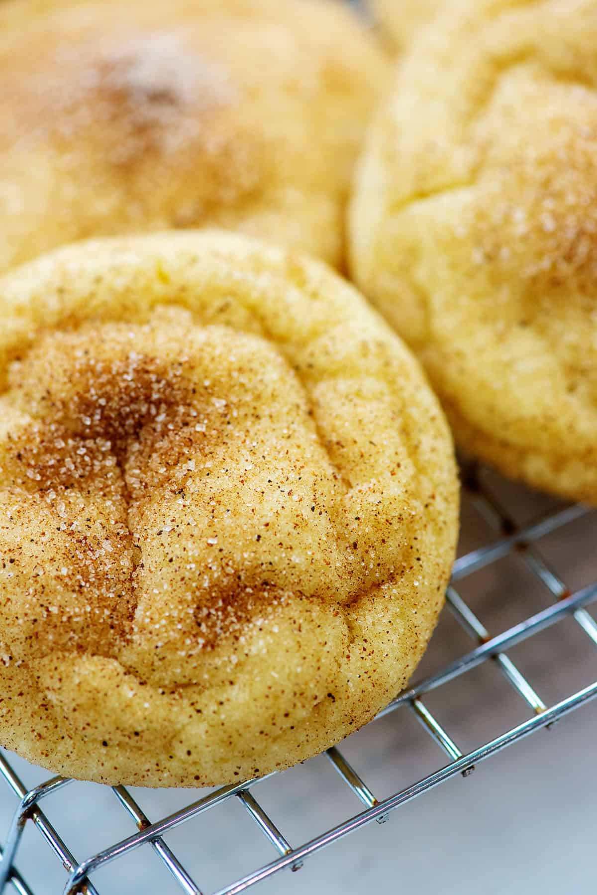 baked snickerdoodle cookies on cooling rack.