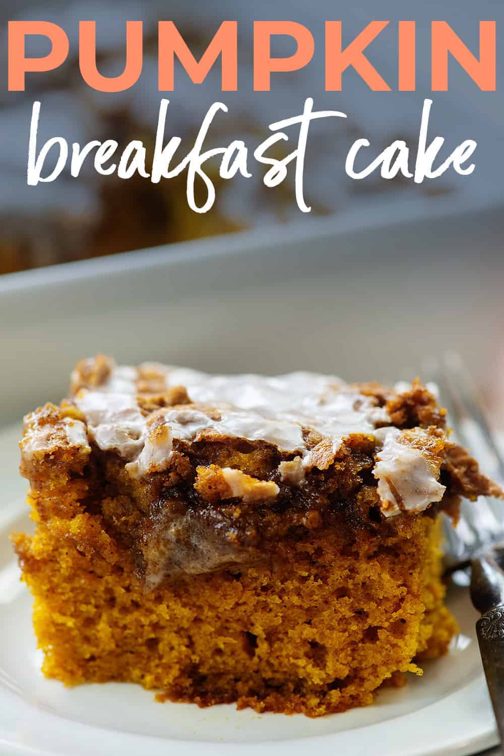 slice of pumpkin cake on white plate with text for Pinterest.