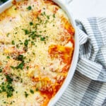 overhead view of baked ravioli in white baking dish.