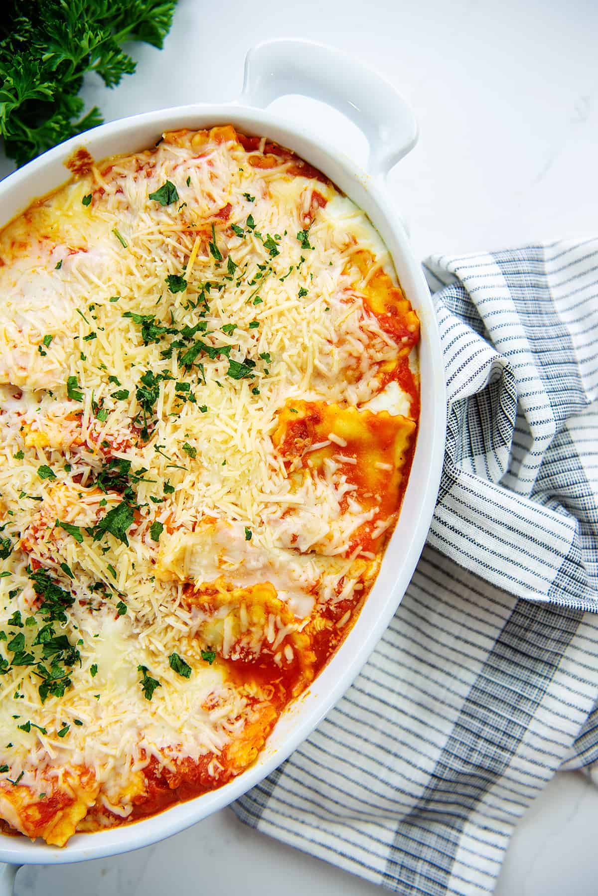 overhead view of baked ravioli in white baking dish.