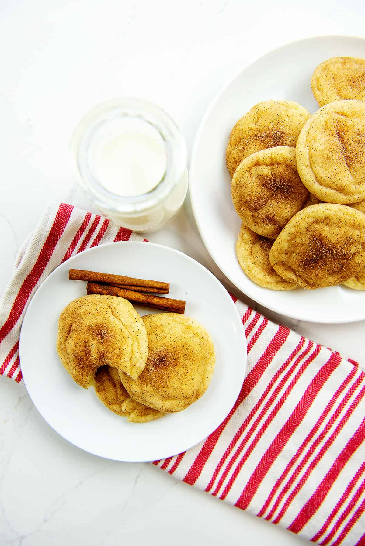 chewy snickerdoodle cookies on white plate with striped napkin.