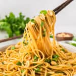 Easy peanut noodle recipe in bowl with chopsticks.
