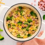 Pot full of broccoli rice with ham.