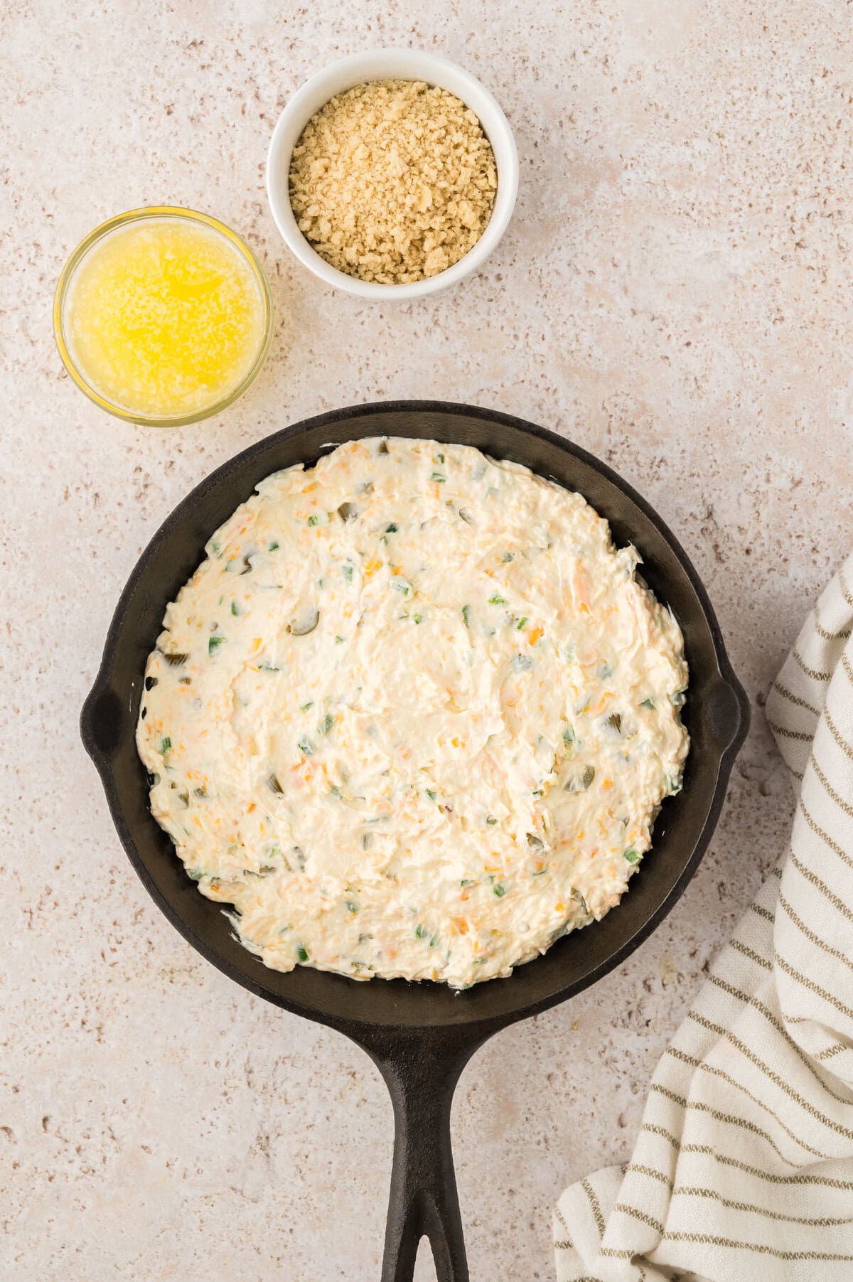 Jalapeno cream cheese dip spread in cast iron skillet.