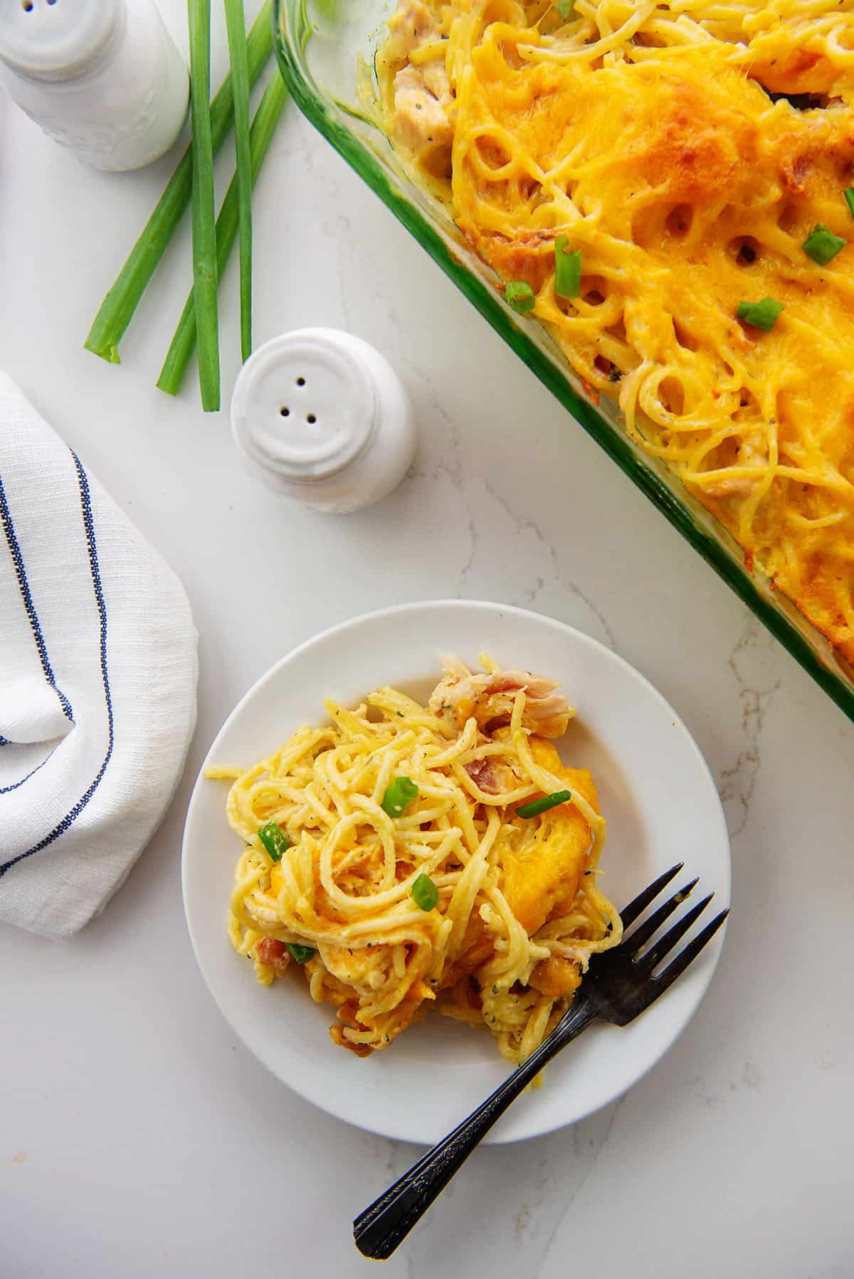 pile of chicken spaghetti on white plate.