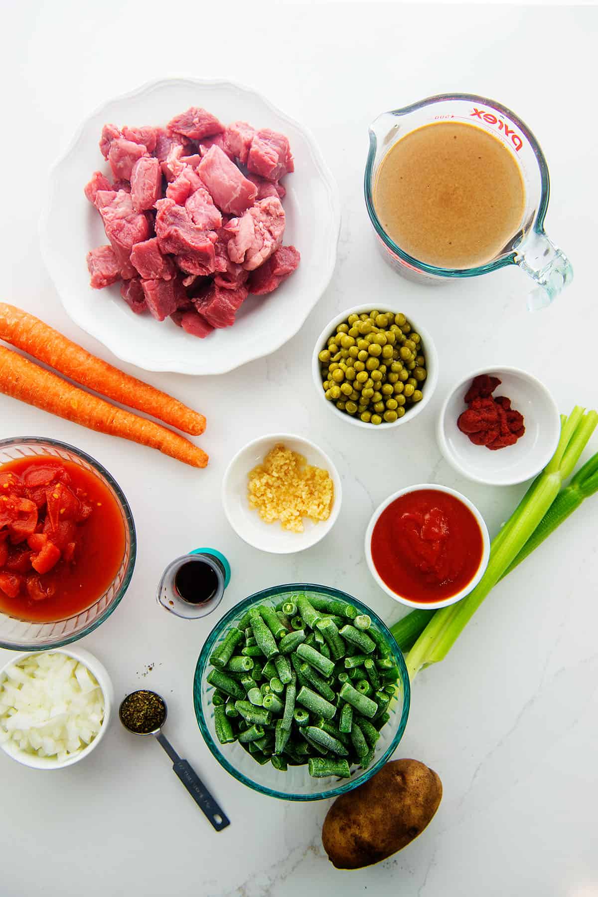 ingredients for vegetable beef soup on counter.