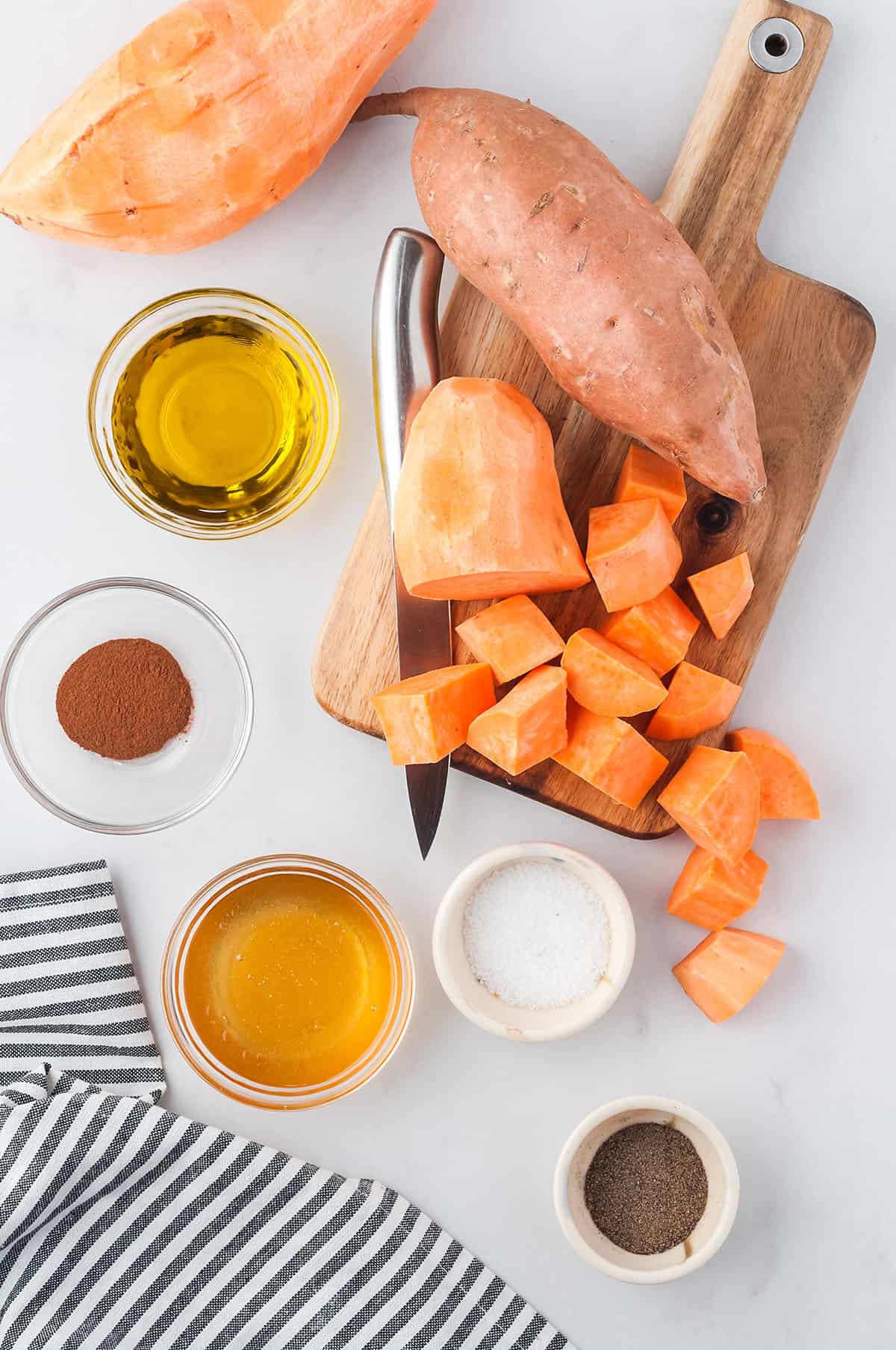 ingredients for roasted sweet potato cubes on board.