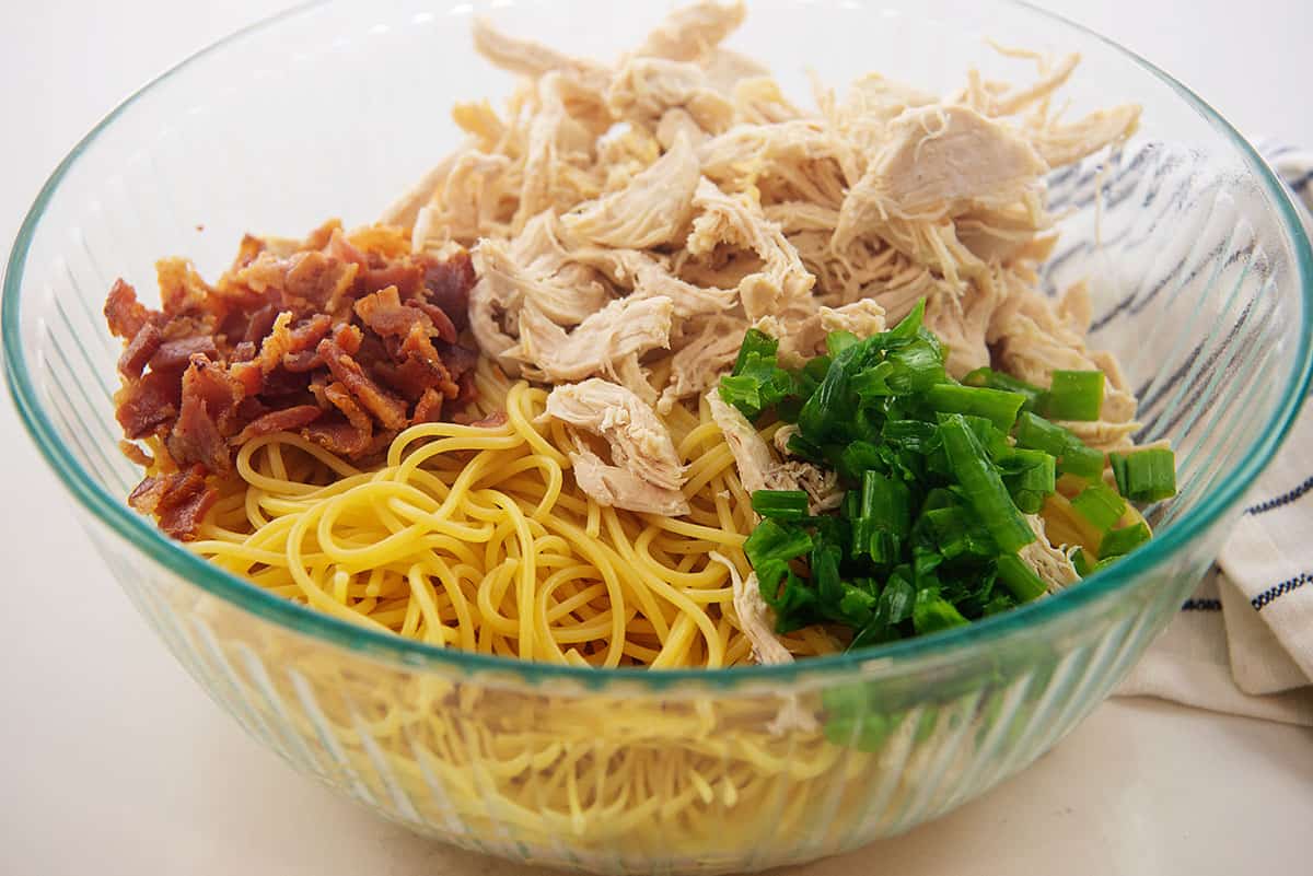 ingredients for chicken spaghetti in glass bowl.