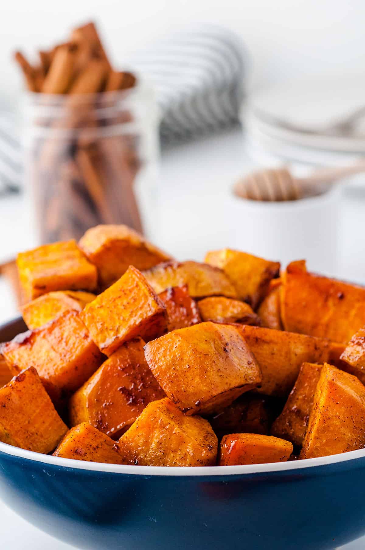 honey roasted sweet potatoes in blue bowl.