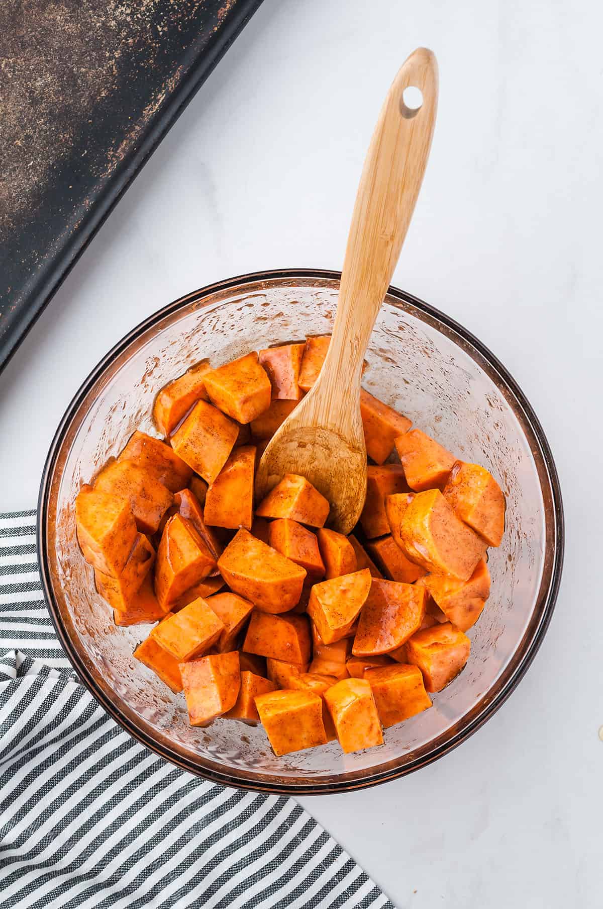 seasoned sweet potato cubes in glass bowl.