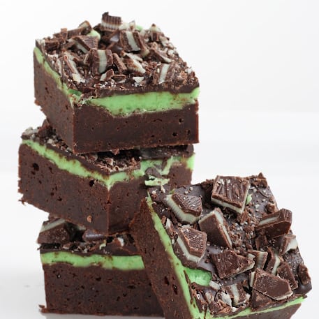 A stack of mint chocolate brownies against a white background.