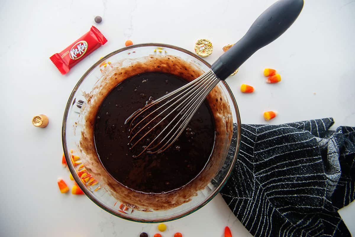 brownie batter in glass mixing bowl.