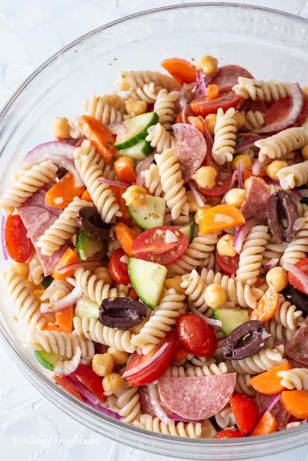 A top down view of gluten free pasta salad in a glass bowl.