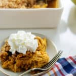 pumpkin crisp on small plate with whipped cream.