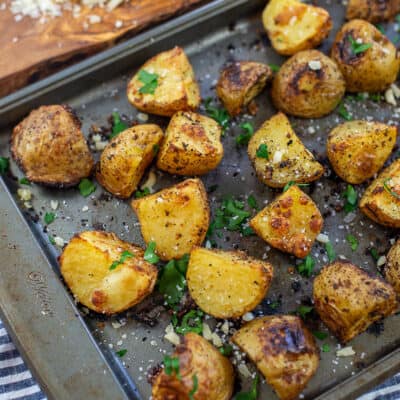 Parmesan roasted potatoes on metal baking sheet.