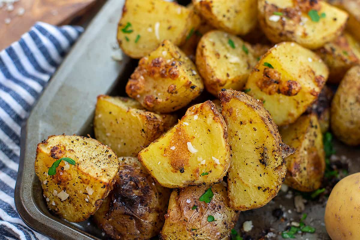 crispy roasted potatoes with Parmesan on baking sheet.