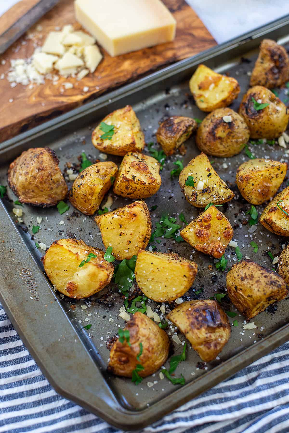 Parmesan roasted potatoes on metal baking sheet.