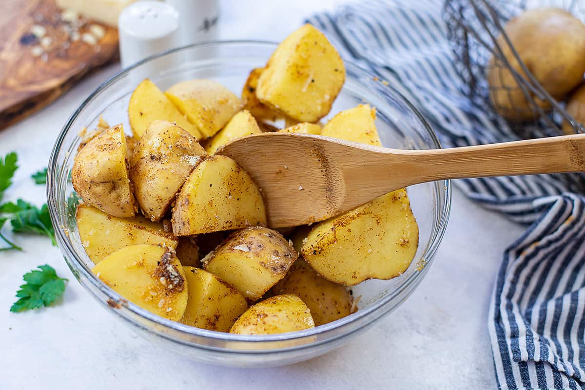 seasoned potatoes in glass bowl.