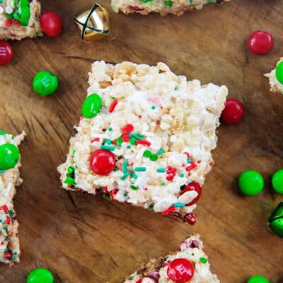 Christmas rice krispies treats on wooden board.