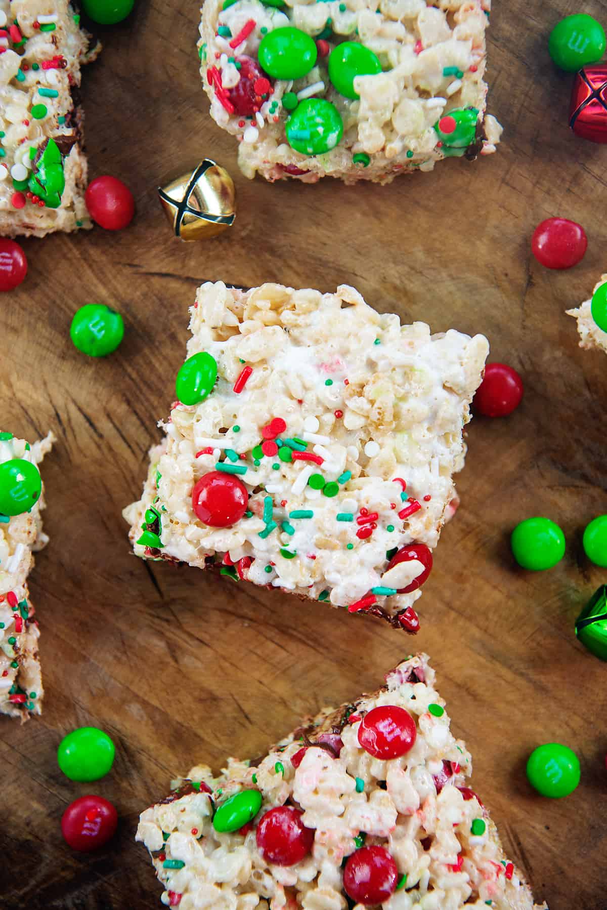 Christmas rice krispies treats on wooden board.