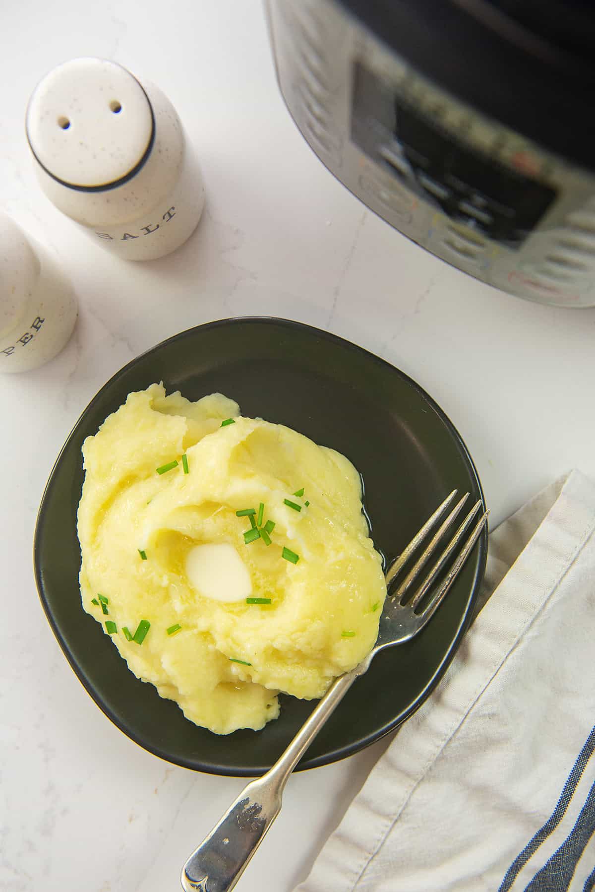 mashed potatoes on black plate.