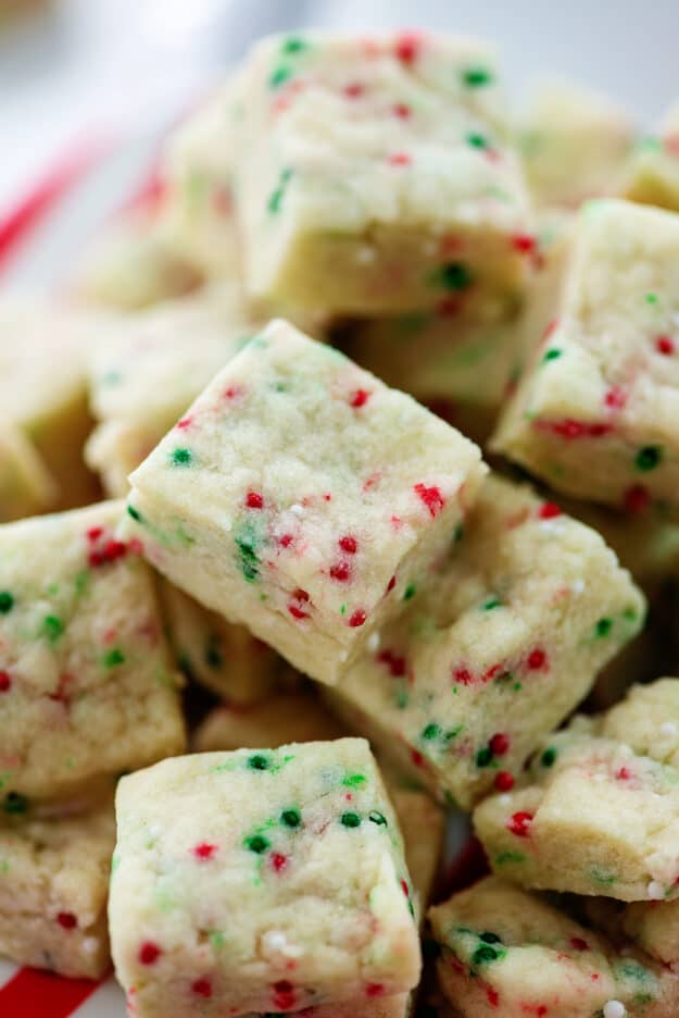 Christmas shortbread bites piled on plate.