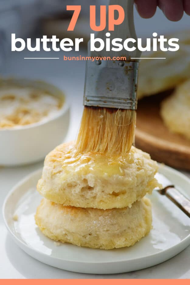 stack of biscuits being brushed with butter.