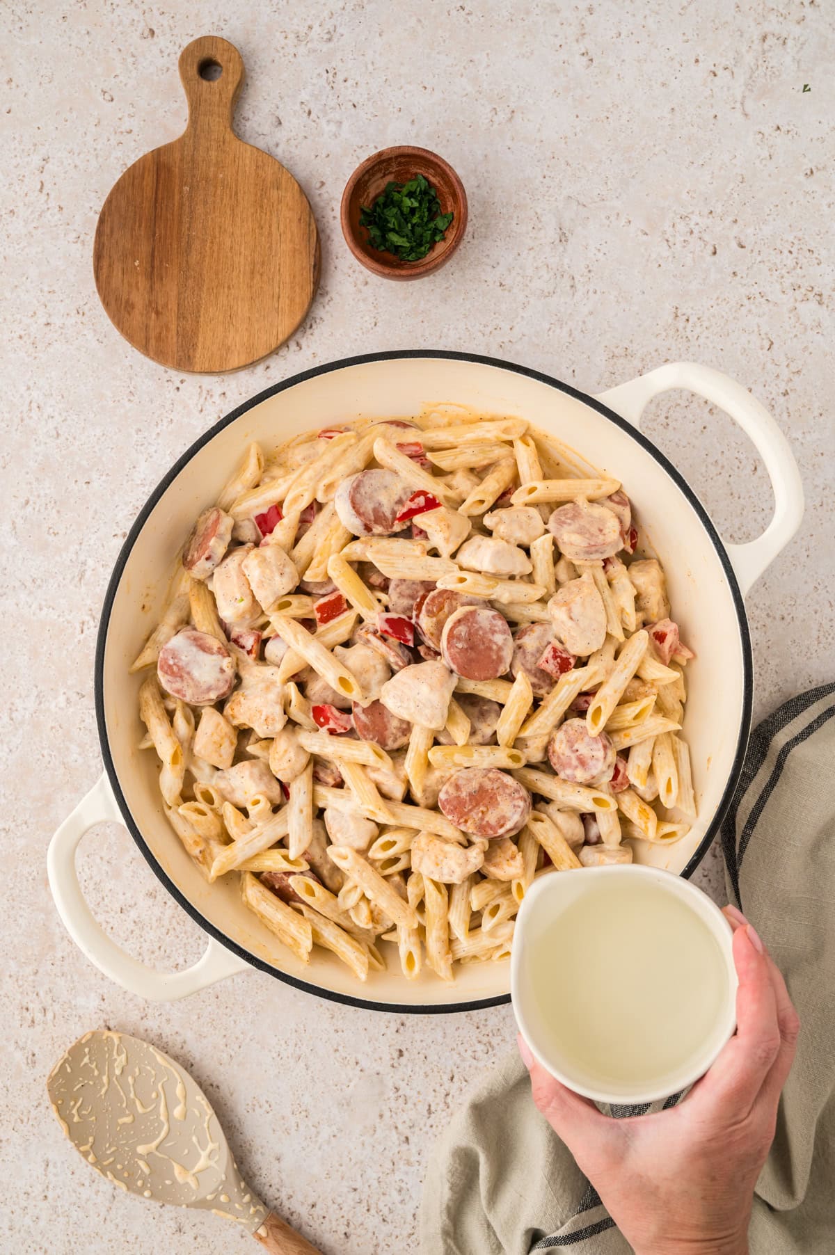Creamy cajun chicken and sausage pasta in skillet.
