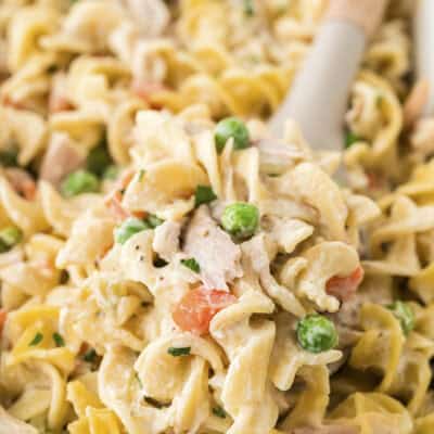 baked chicken noodle casserole in white baking dish.