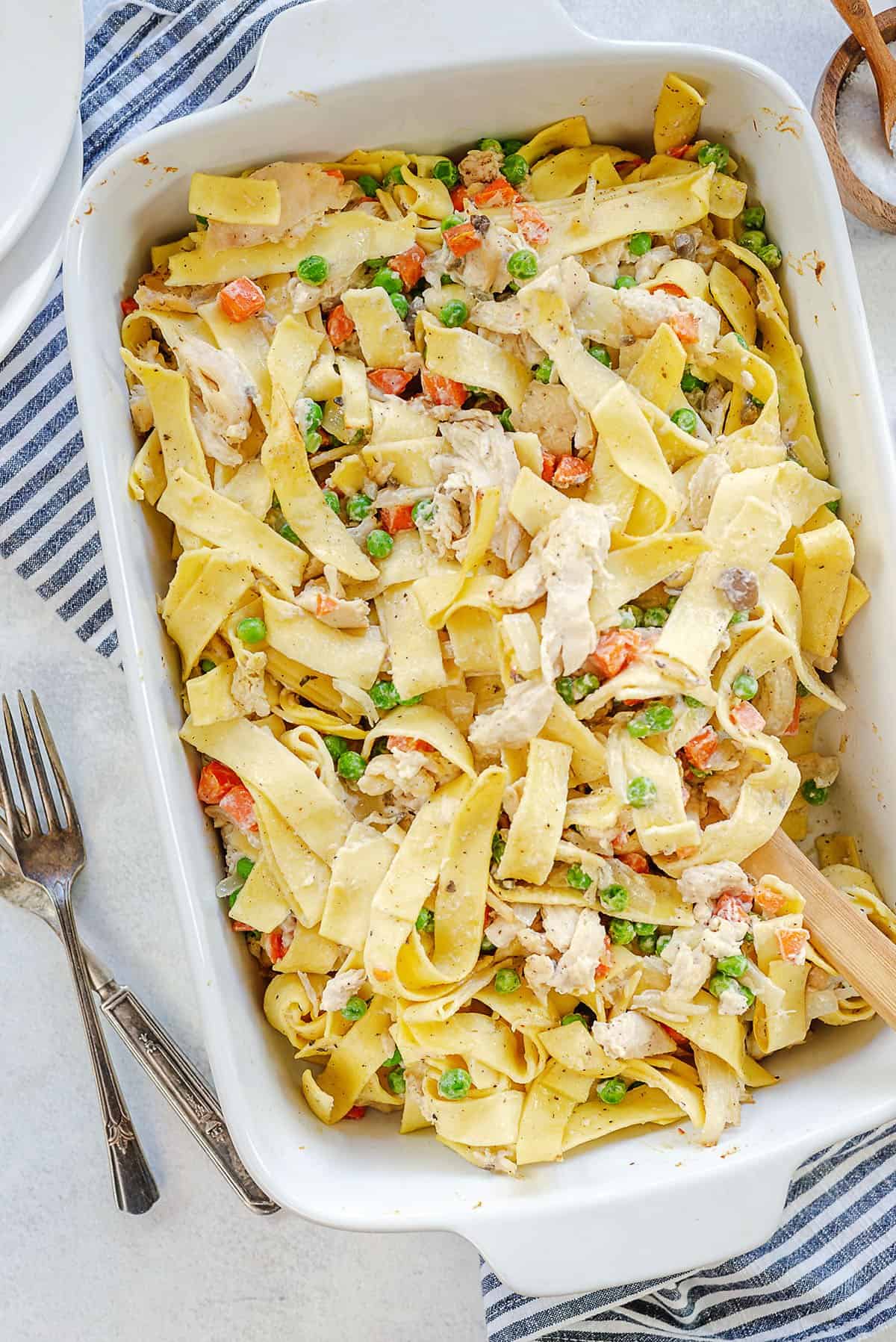 baked chicken noodle casserole in white baking dish.