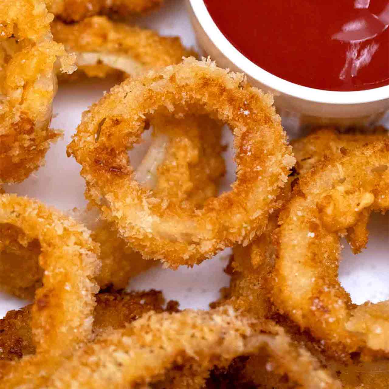 onion rings next to ketchup.