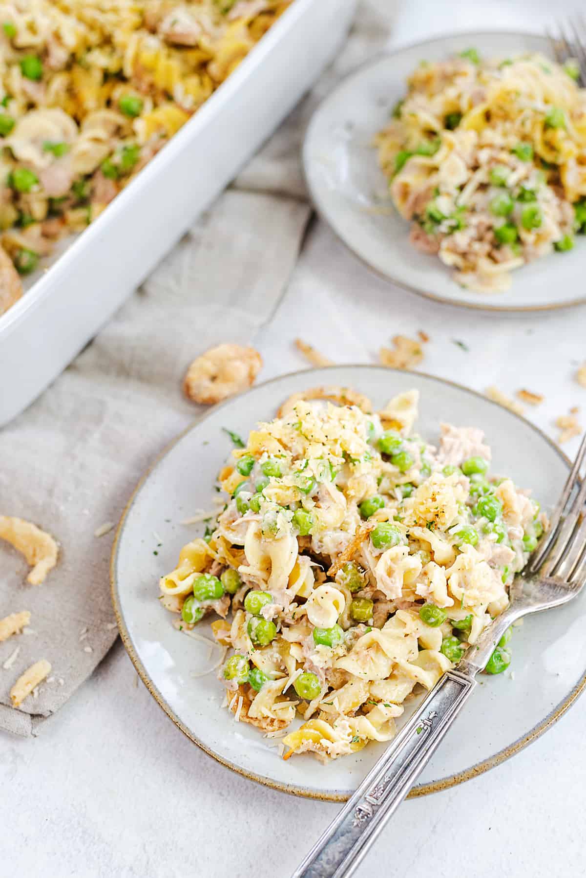 classic tuna noodle casserole recipe on white plates.