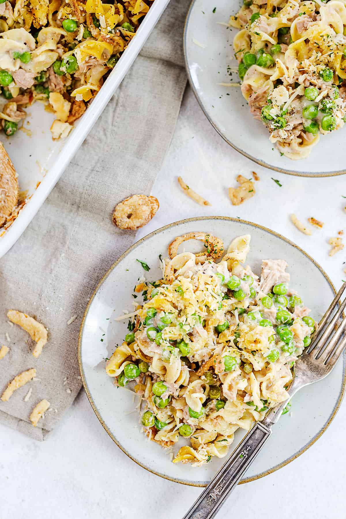 tuna noodle casserole on white plates.