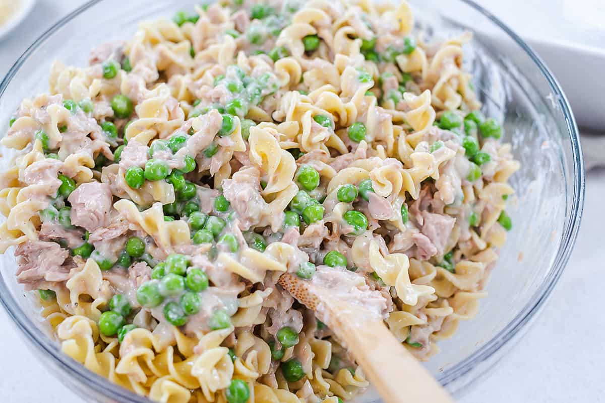 classic tuna noodle casserole ingredinets in mixing bowl.