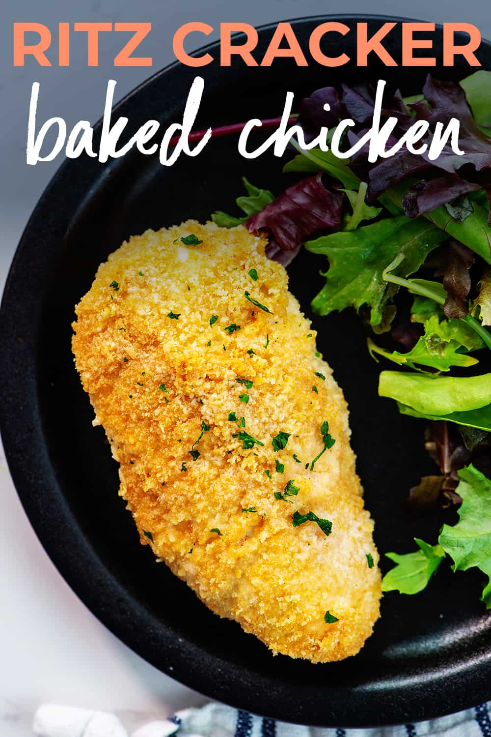 overhead view of ritz cracker baked chicken on a plate with salad.
