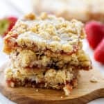 strawberry oatmeal bars on small round board.
