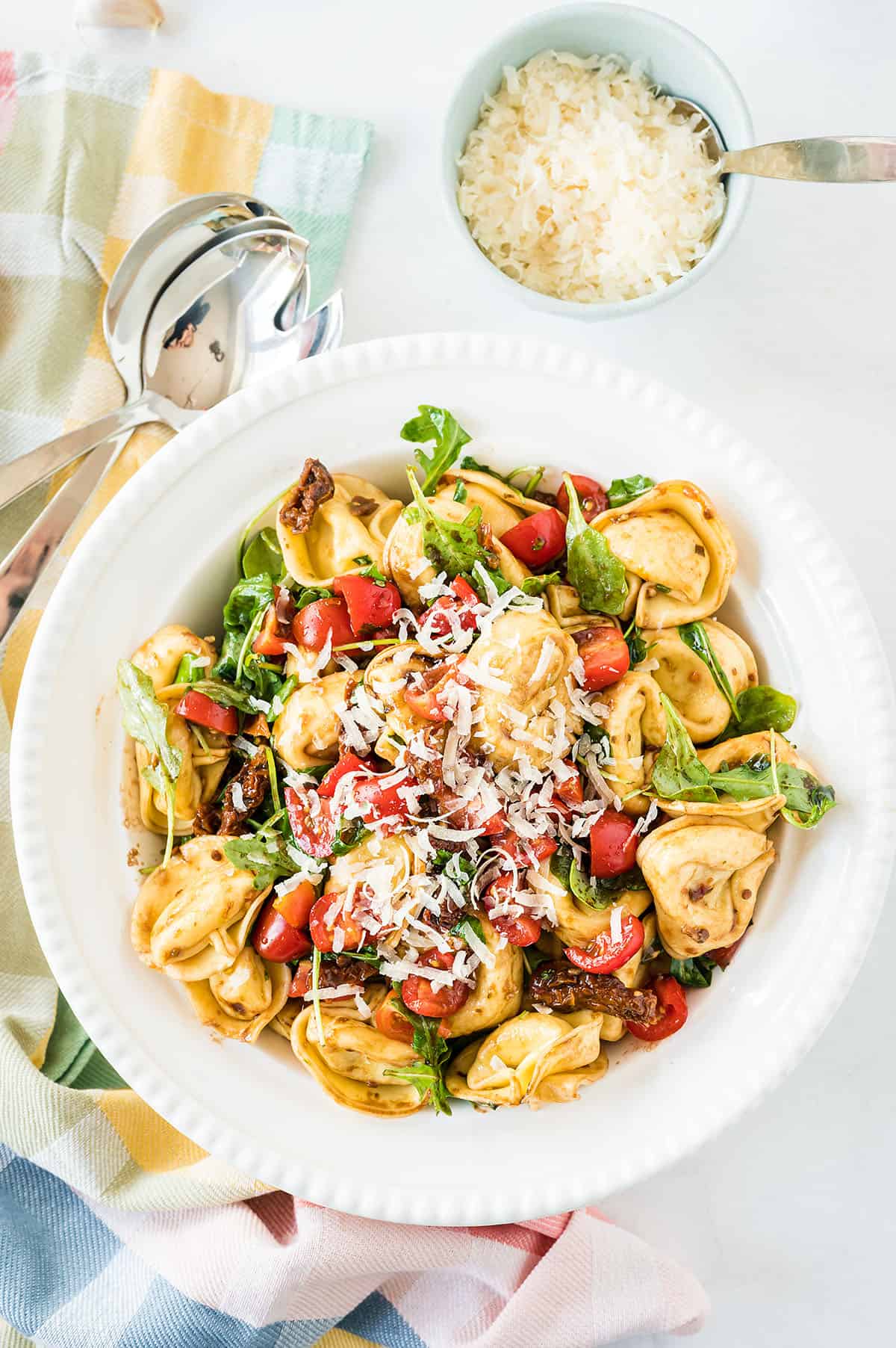 Tortellini pasta salad in white bowl.