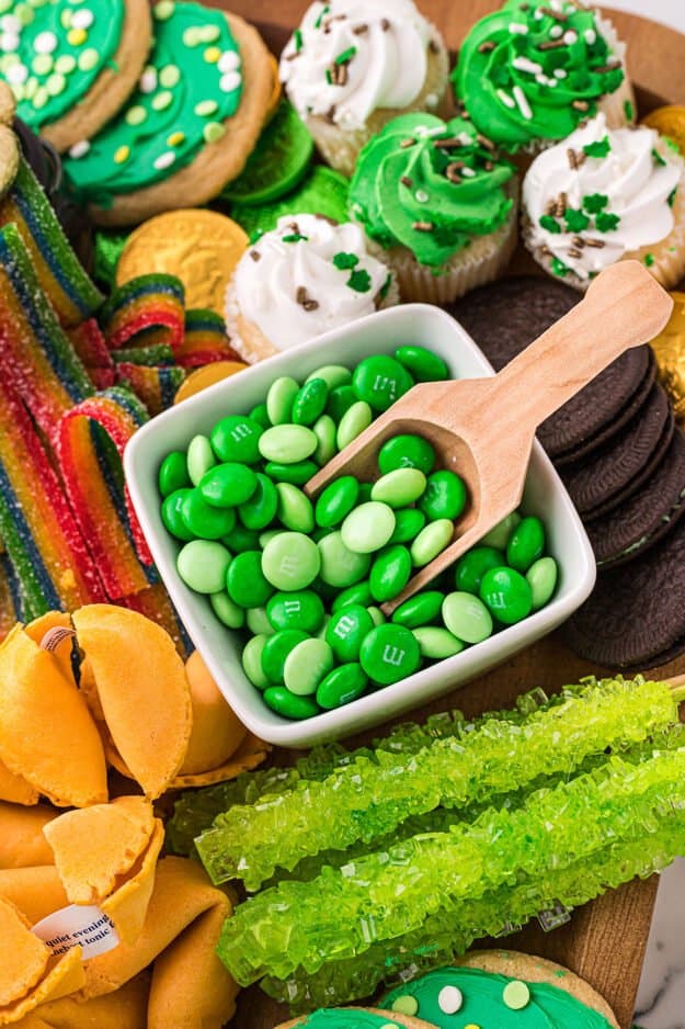 m&m candies in bowl on snack board.