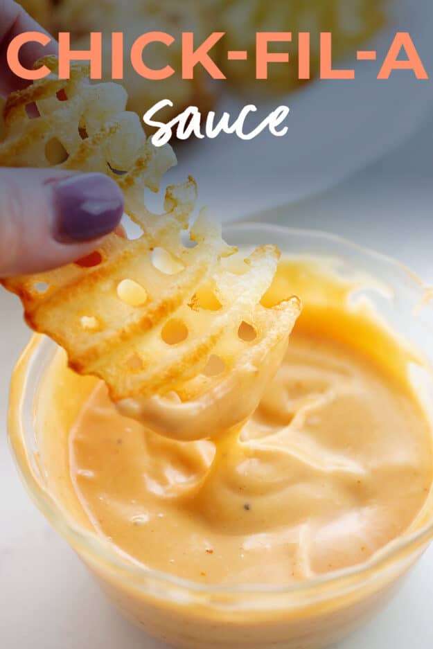 waffle fry being dipped in sauce.